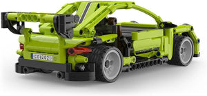 Green toy tow truck made of interlocking bricks on a white background