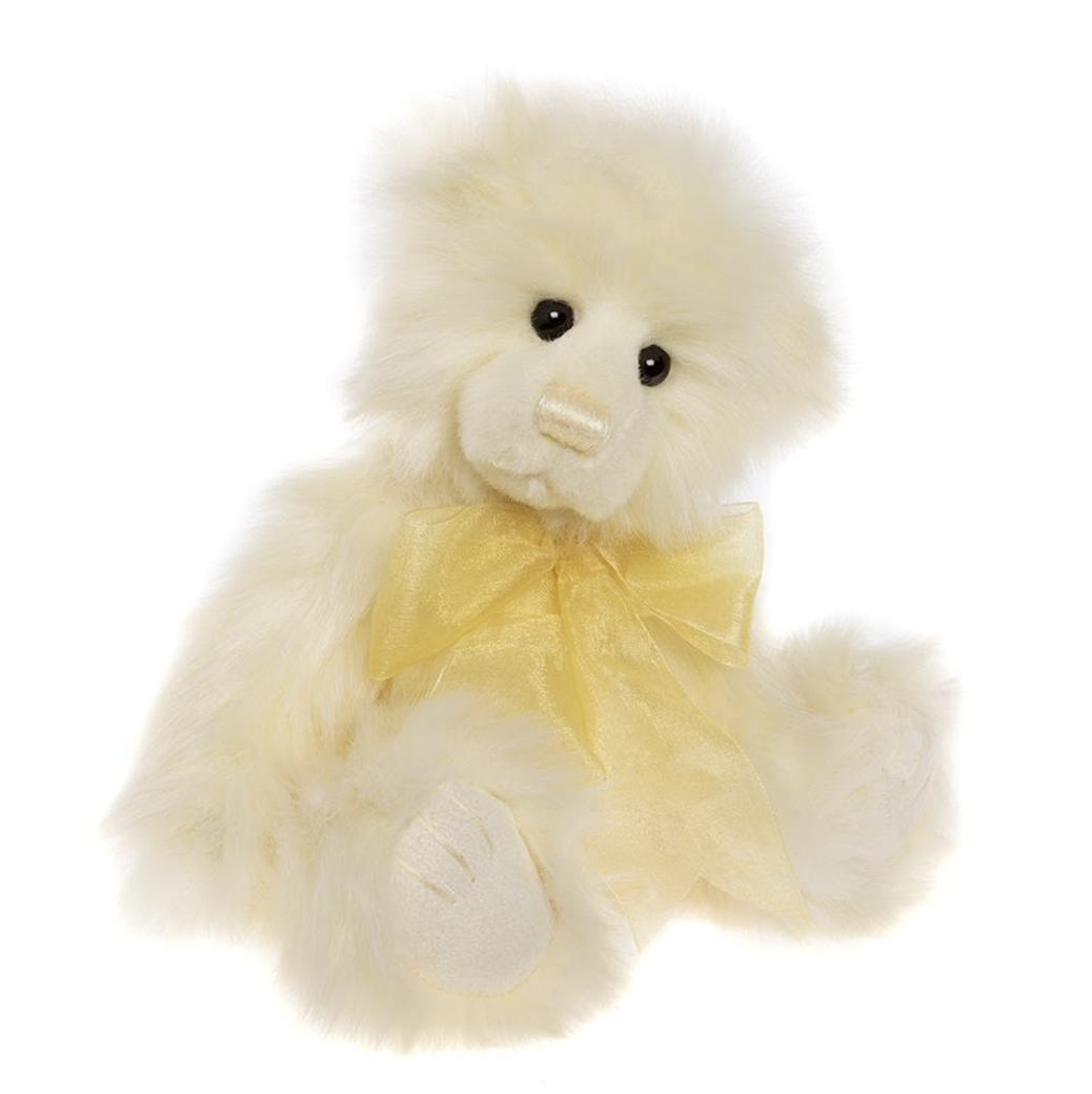 White teddy bear with a yellow bow on a white background