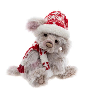 Plush teddy bear wearing a red and white knitted hat and scarf on a white background