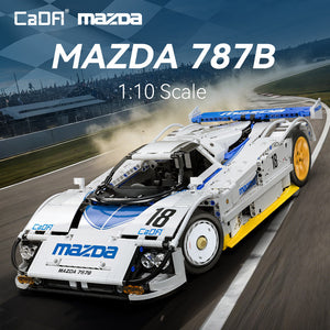 Model of a Mazda 787B race car on a racetrack with 'CaDA' branding.