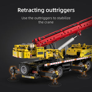 Model crane with retracting outriggers on a dark background