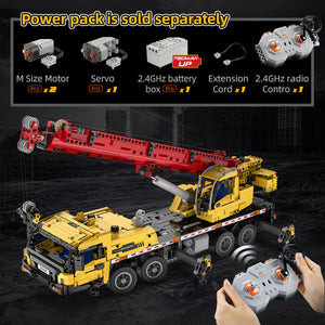 Toy crane set with remote control and power pack components displayed on a dark background.