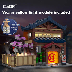 Model of a traditional Japanese building with warm yellow light module included, featuring cherry blossoms and a lantern.