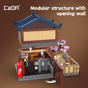 Modular building model with opening wall on a brown background, featuring the brand 'CaDA'.