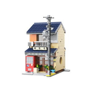 Model of a small building with a blue roof and red door on a white background