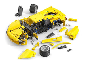 Yellow toy car model with various parts on a white background, featuring the Brickmo brand.