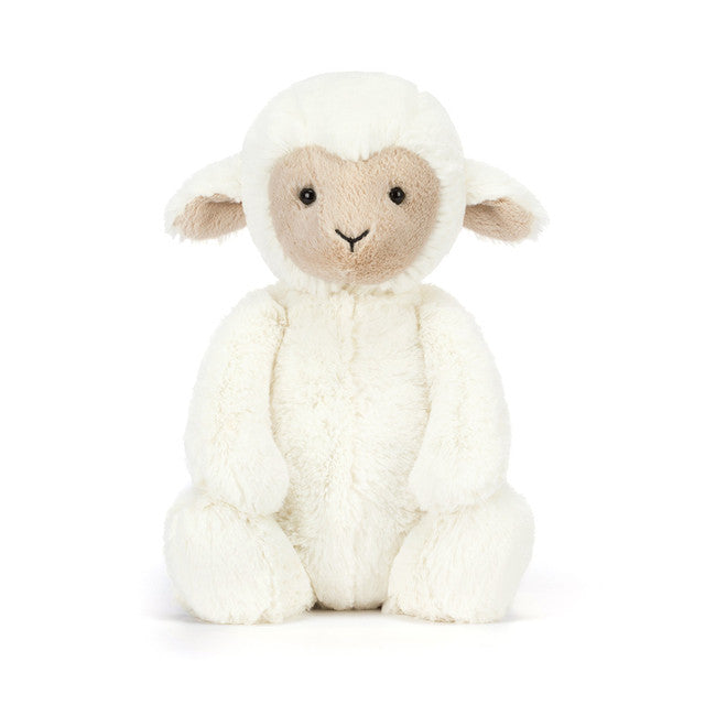 White plush lamb toy on a white background