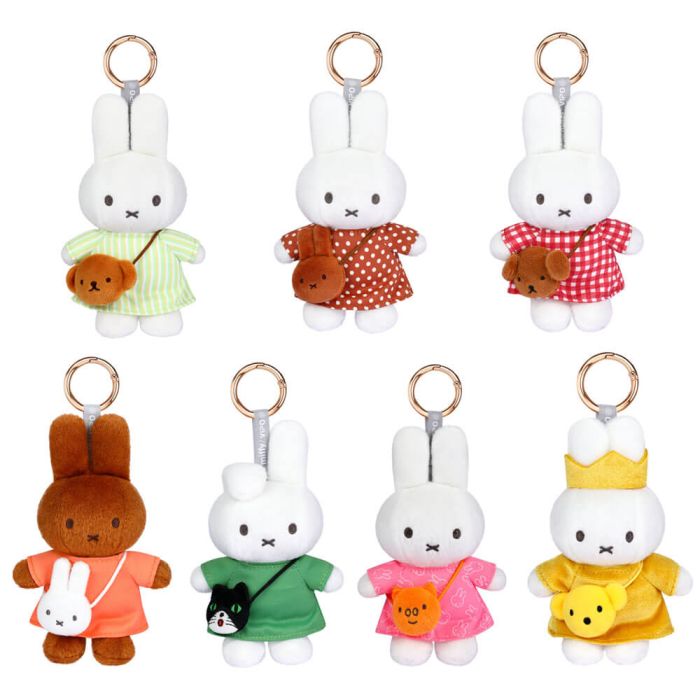 Set of plush keychains with cartoon characters in various outfits on a white background