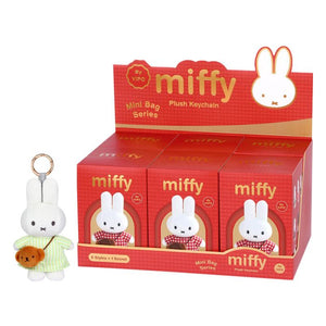 Red packaging display of Miffy plush keychains with a small Miffy figure in front.