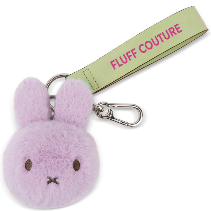 Purple fluffy keychain with a green strap labeled 'Fluff Couture' on a white background