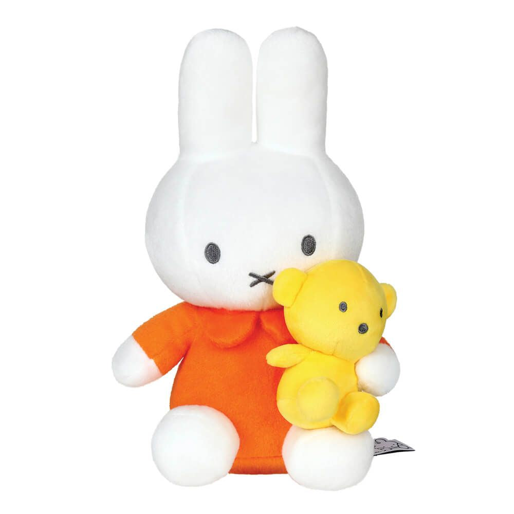 Plush toy rabbit in an orange outfit holding a yellow teddy bear on a white background