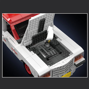 Close-up of a LEGO model of a vehicle with an open cargo area on a dark background
