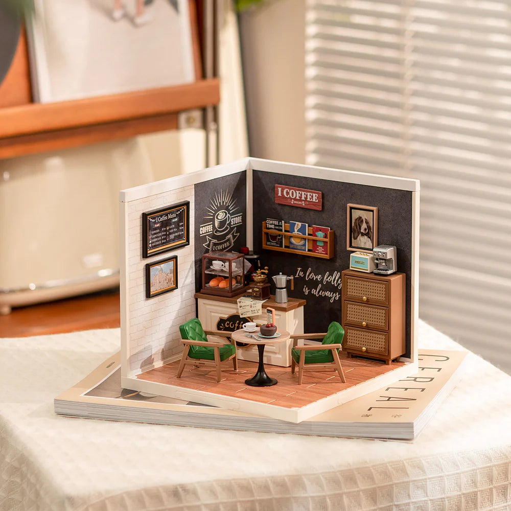 Miniature model of a coffee shop inside an open book