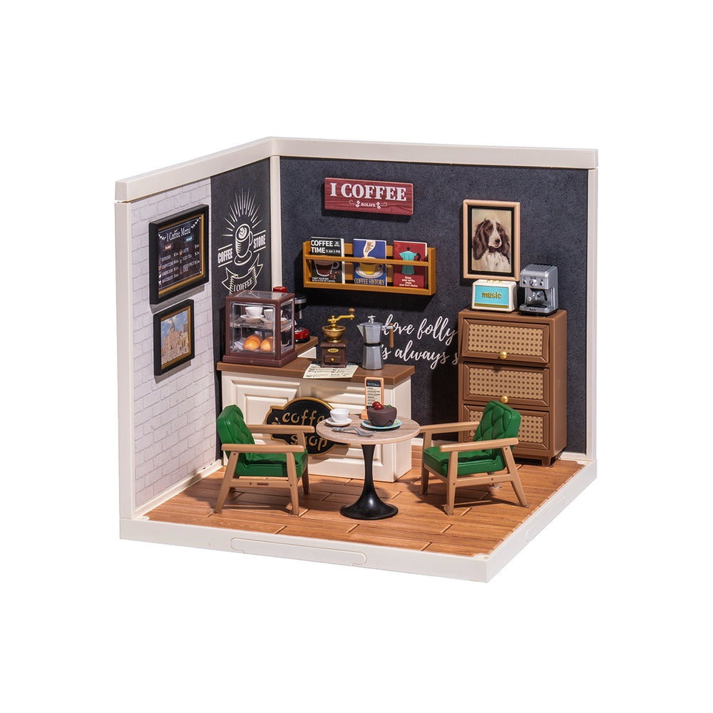 Miniature model of a coffee shop interior with furniture and decor.