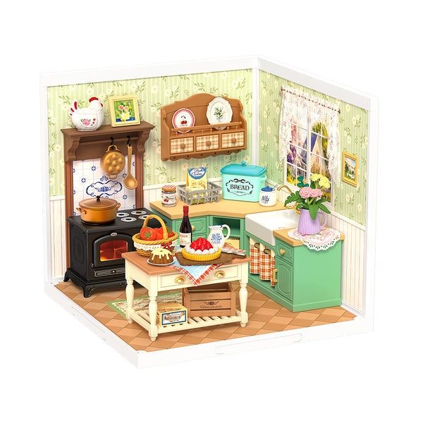 Miniature model of a kitchen with various appliances and decor items on a white background