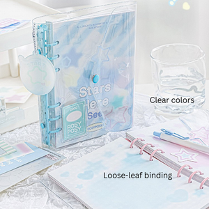 Clear planner with loose-leaf binding on a light surface