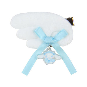 White cloud-shaped object with a blue ribbon and bear charm on a white background