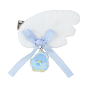 White baby bootie with a blue ribbon and duck charm on a white background