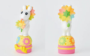 Two colorful unicorn toys with flower designs on a white background