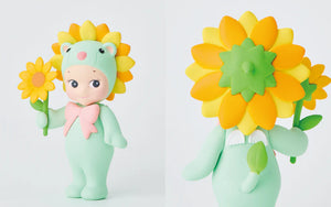 Toy figure in a green outfit with sunflower accessories on a white background