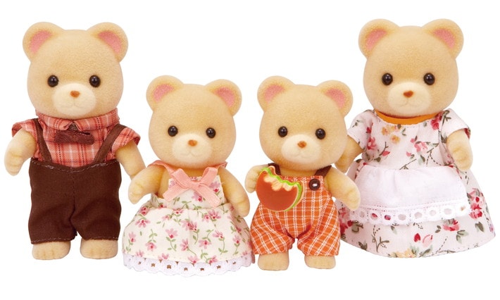 Four teddy bear toys with different outfits on a white background