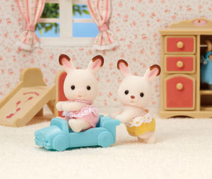 ylvanian Families Chocolate Rabbit Twins playing with blue ride-on car toy