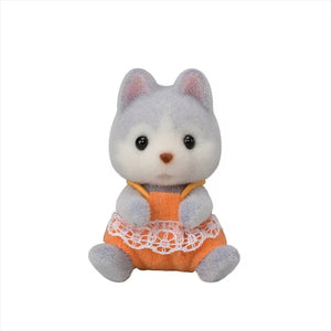 Plush toy cat in an orange outfit with a white lace trim on a white background