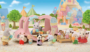 Toy figures of animals and children in a park setting with an ice cream truck and balloons.