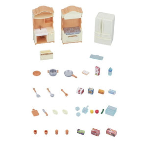 Set of miniature kitchen furniture and accessories on a white background