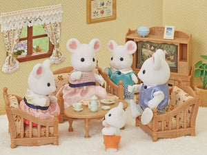 Toy mouse family in a living room setting with furniture and decor.