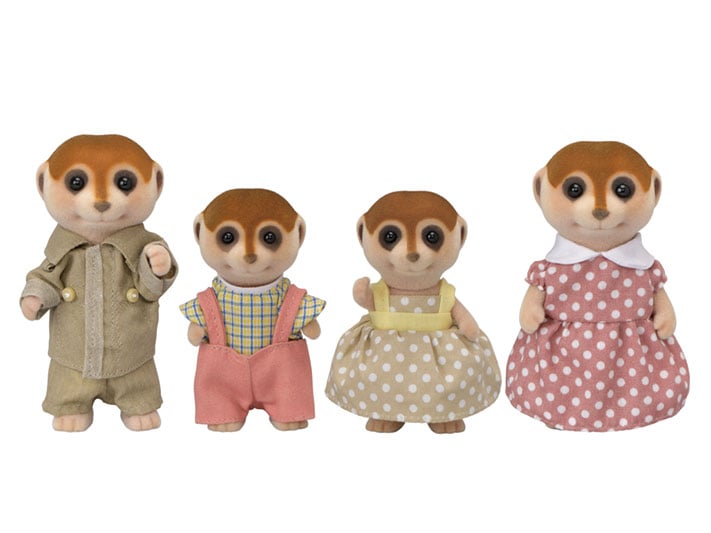 Four toy meerkats dressed in outfits on a white background