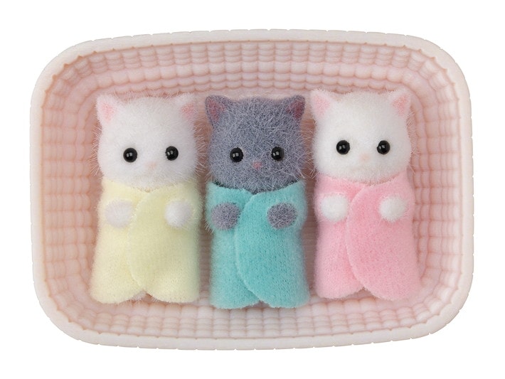 Three small plush cats in pastel colors sitting in a textured pink container.