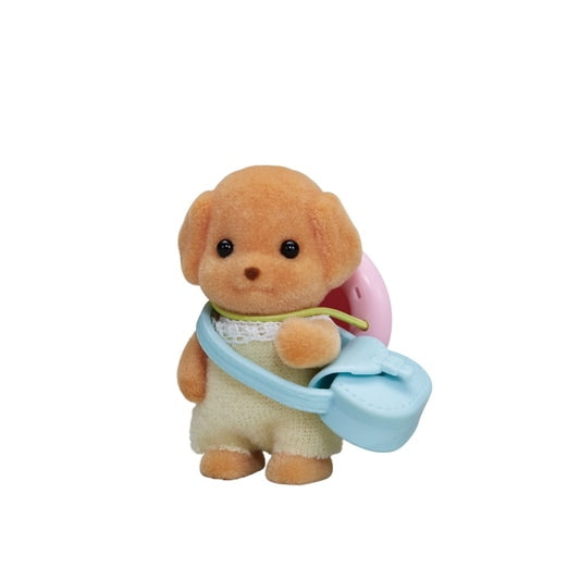 Small plush toy dog holding a pink balloon on a white background