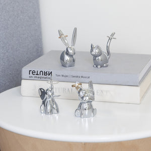 Umbra Zoola Ring Holder collection featuring shiny chrome animal designs on a modern bookshelf.