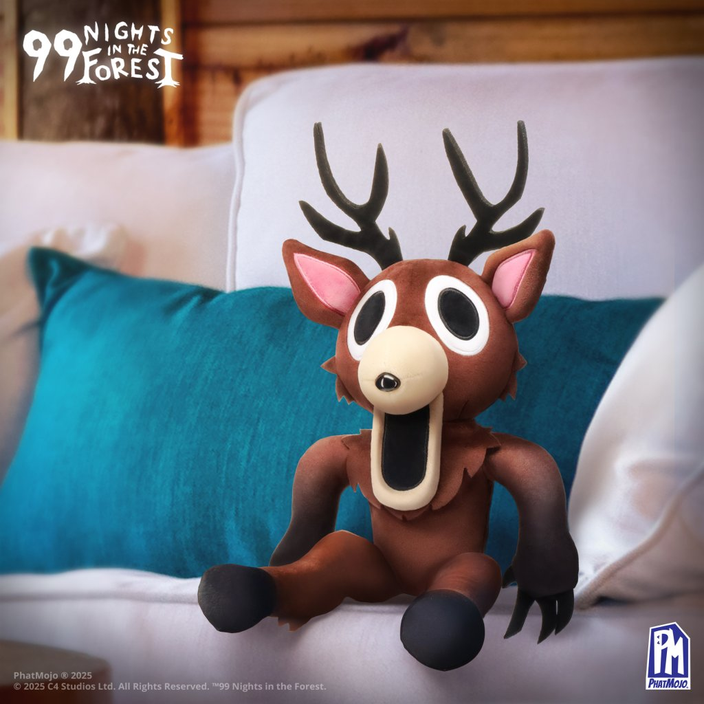 99 Nights in the Forest Deluxe Plush - The Deer sitting on a couch with a blue cushion in the background.