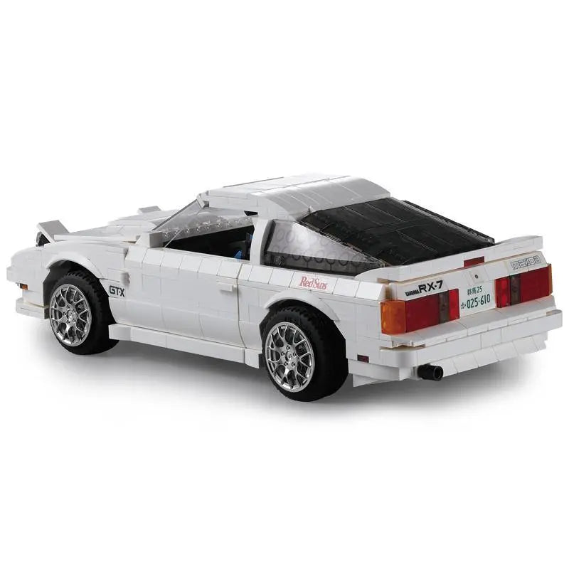 Model car made of interlocking bricks on a white background