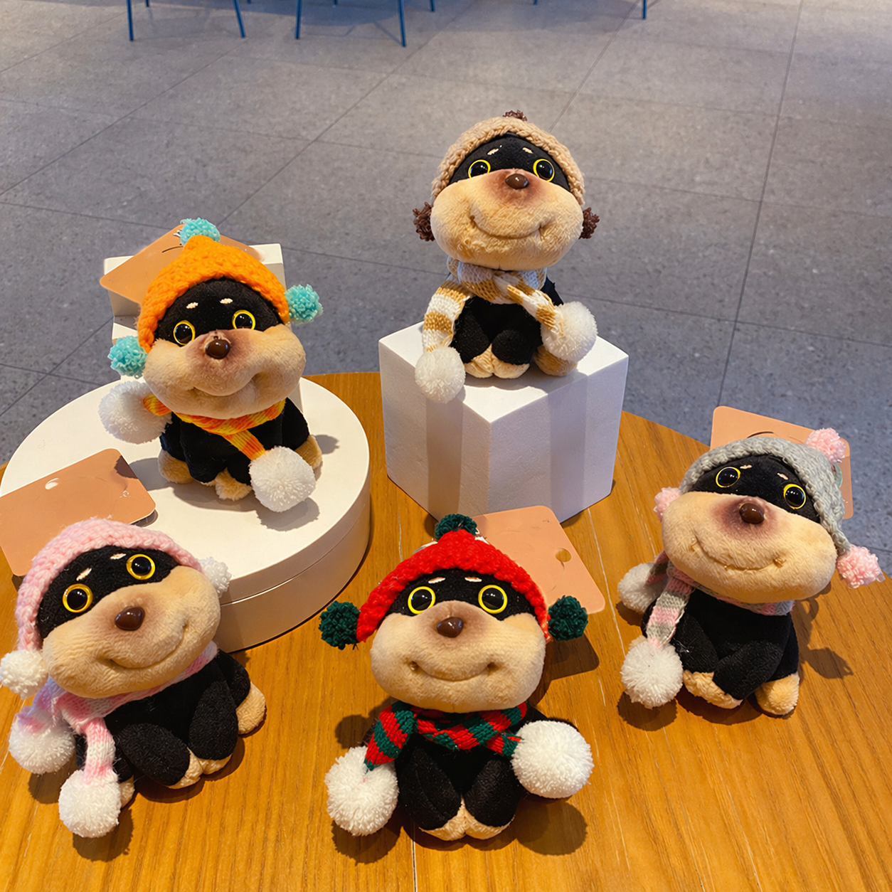 Cute Puppy Plush Keychain with Hat & Scarf  Bag Charm - Assorted Colours displayed on a table.