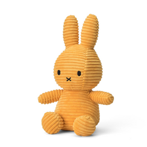 Yellow plush bunny toy on a white background