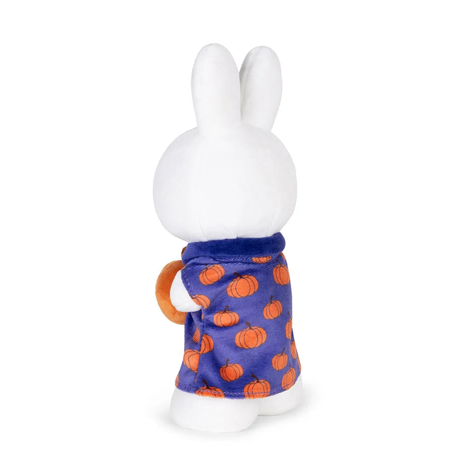 White rabbit figure wearing a blue sweater with orange pumpkin pattern on a white background