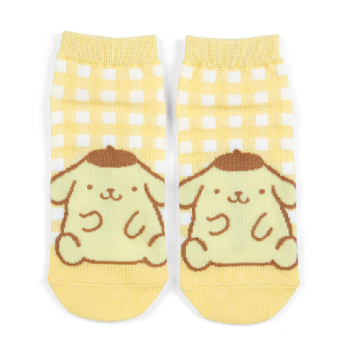 Pair of socks with cartoon dog design on a yellow background