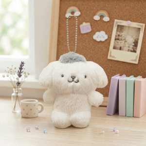 Sanrio Pompompurin Monochrome Plush Mascot Keychain Charm on a desk with stationery and a corkboard.