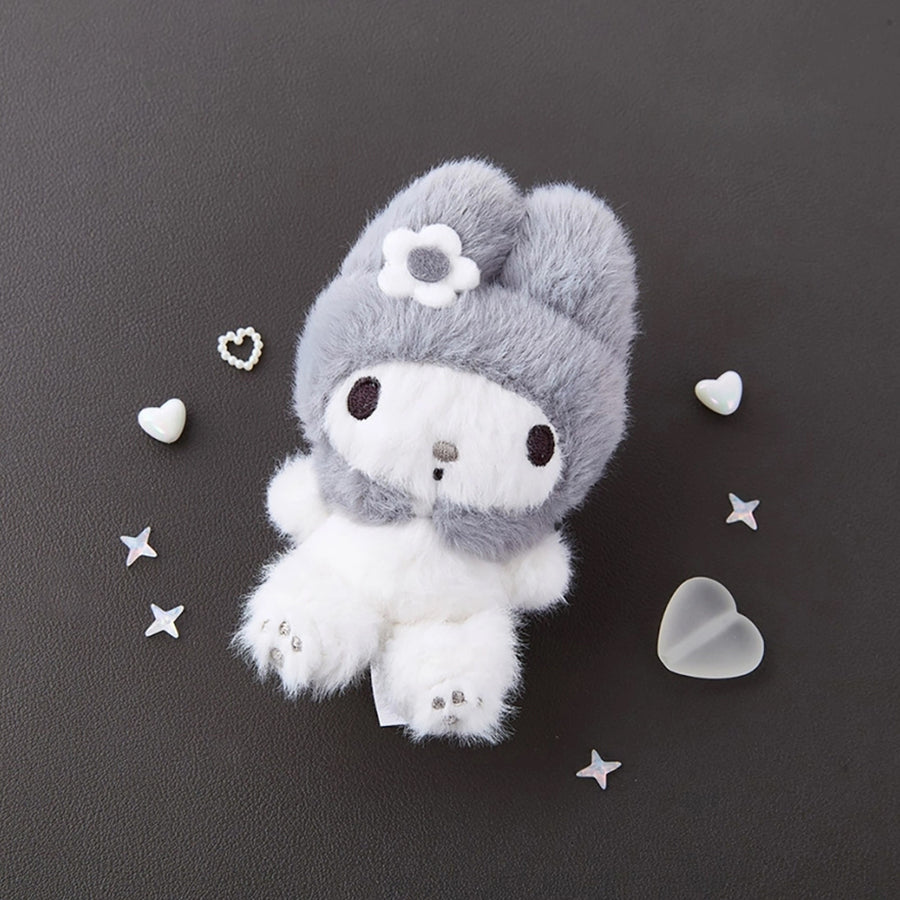 Sanrio My Melody Monochrome Plush Mascot Keychain Charm on a dark surface, surrounded by decorative hearts and stars.