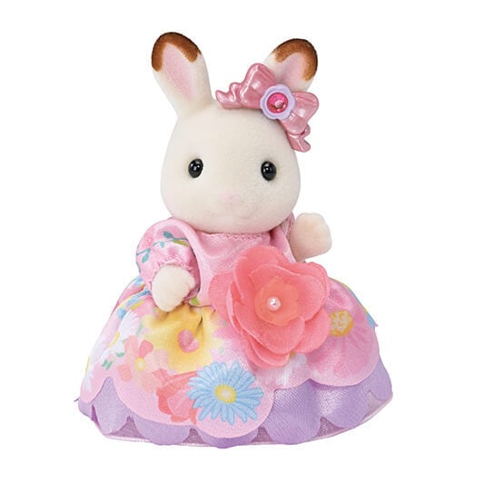 Toy rabbit figure with a pink dress and flower accessories on a white background