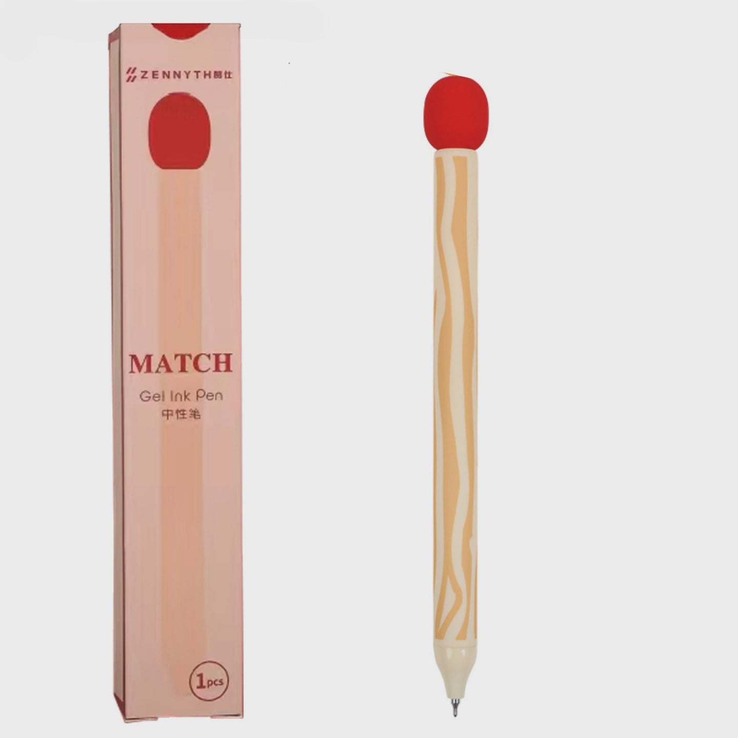 A gel ink pen shaped like a match, with a light wood-grain handle, a red circular top, and a silver tip, shown next to its pink packaging box on a light gray background.