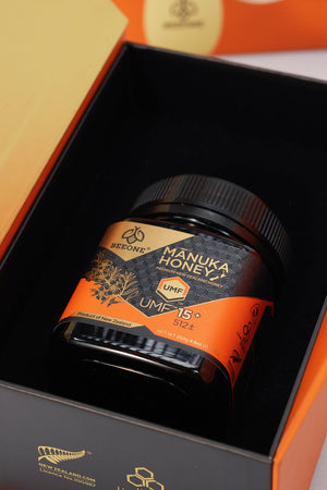 Manuka Honey jar with UMF 15+ on an orange and black background