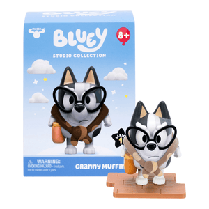 Bluey figurine with glasses and toy box in the background