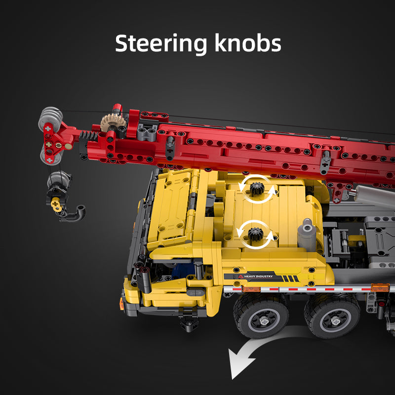 Model of a crane truck with steering knobs highlighted on a dark background