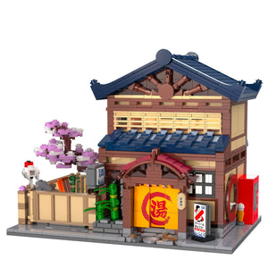 Detailed model of a traditional Japanese building with cherry blossom tree and various elements on a white background