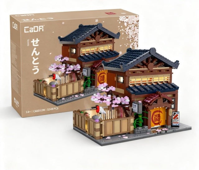 Model of a traditional Japanese building with cherry blossoms and a CaoR box in the background.