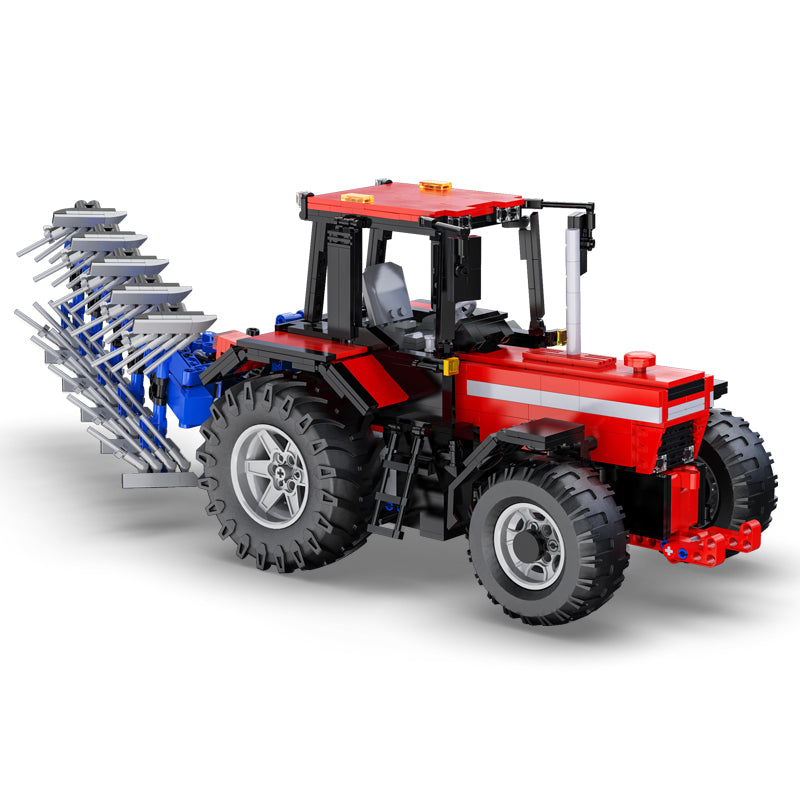 Red tractor model made of interlocking bricks on a white background